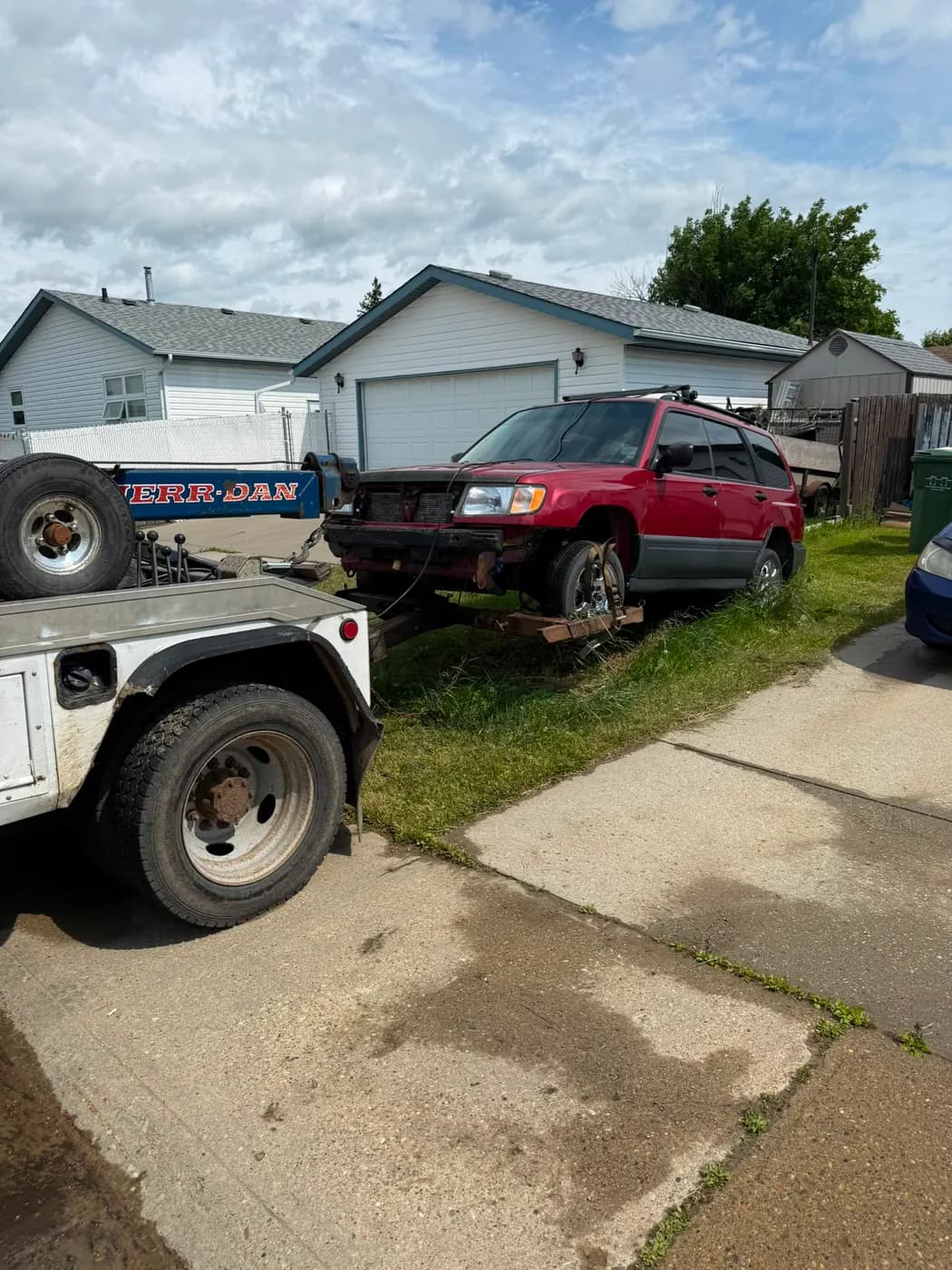 Red 2002 Subaru Forester collected for cash in downtown Leduc, Alberta