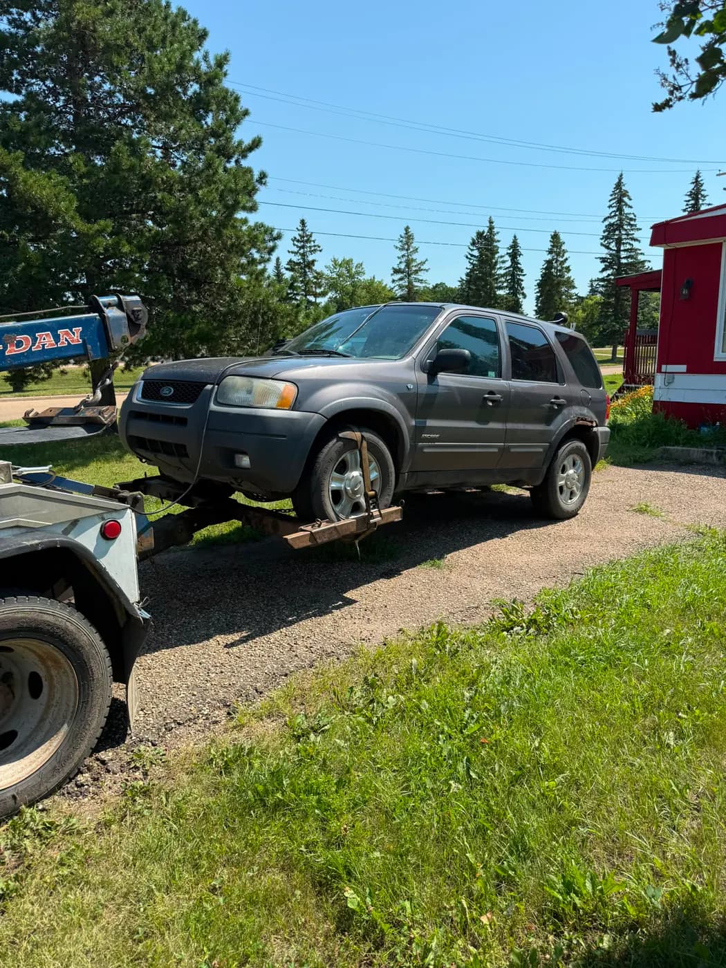 Dark grey 2005 Ford Escape collected for cash in downtown Forestburg, Alberta