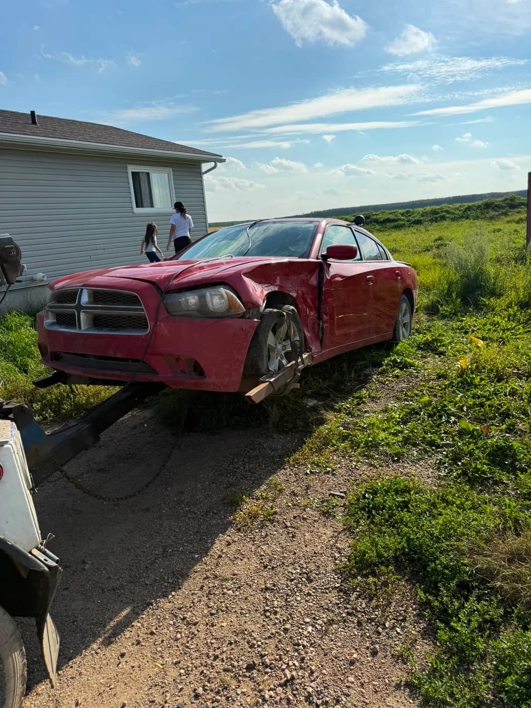 Red 2013 Dodge Charger collected for cash near Saddle Lake Cree Nation, Alberta